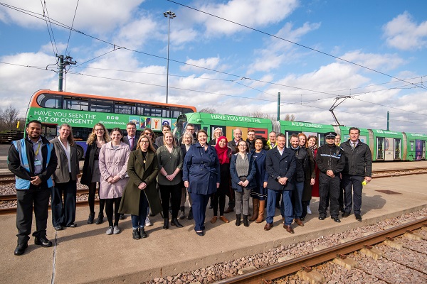 People involved with the A-Z of Consent stood in front of the bus and tram