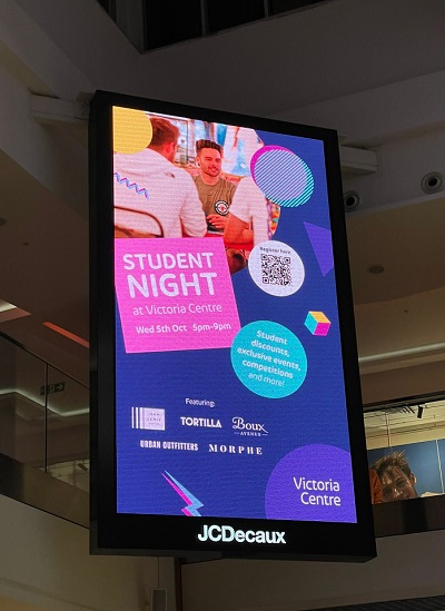Advert for the Student Night/Student Village on a lit-up screen
