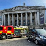 Photo of a fire engine and a community fire vehicle wrapped in the 'Safe Space Pledge' in front of the Nottingham Council House, Old Market Square
