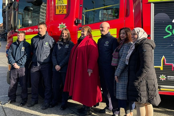 Photo of Nottinghamshire Police and Crime Commissioner Caroline Henry, alongside Nottinghamshire Fire and Rescue Service staff, other representatives in front of a Fire Engine wrapped in the 'Safe Space Pledge'