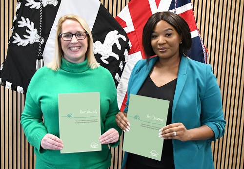 Photo of Louise Graham (CC Manager) and DPCC Nicolle Ndiweni-Roberts holding up copies of the new 'Your Journey - Derbyshire' guide