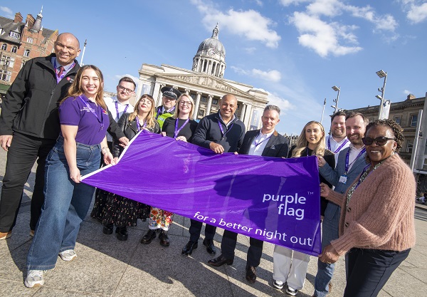 Representatives holding up the purple flag