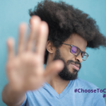 A black man holding up his hand as if to say 'stop' with the hashtag #ChooseToChallenge and #IWD2021
