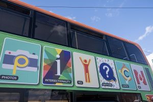 The side of the bus shows some of the things covered in the A-Z of consent - photos, intersectionality, yes, questions, choice and no