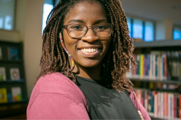 Picture of a Black woman smiling in a library