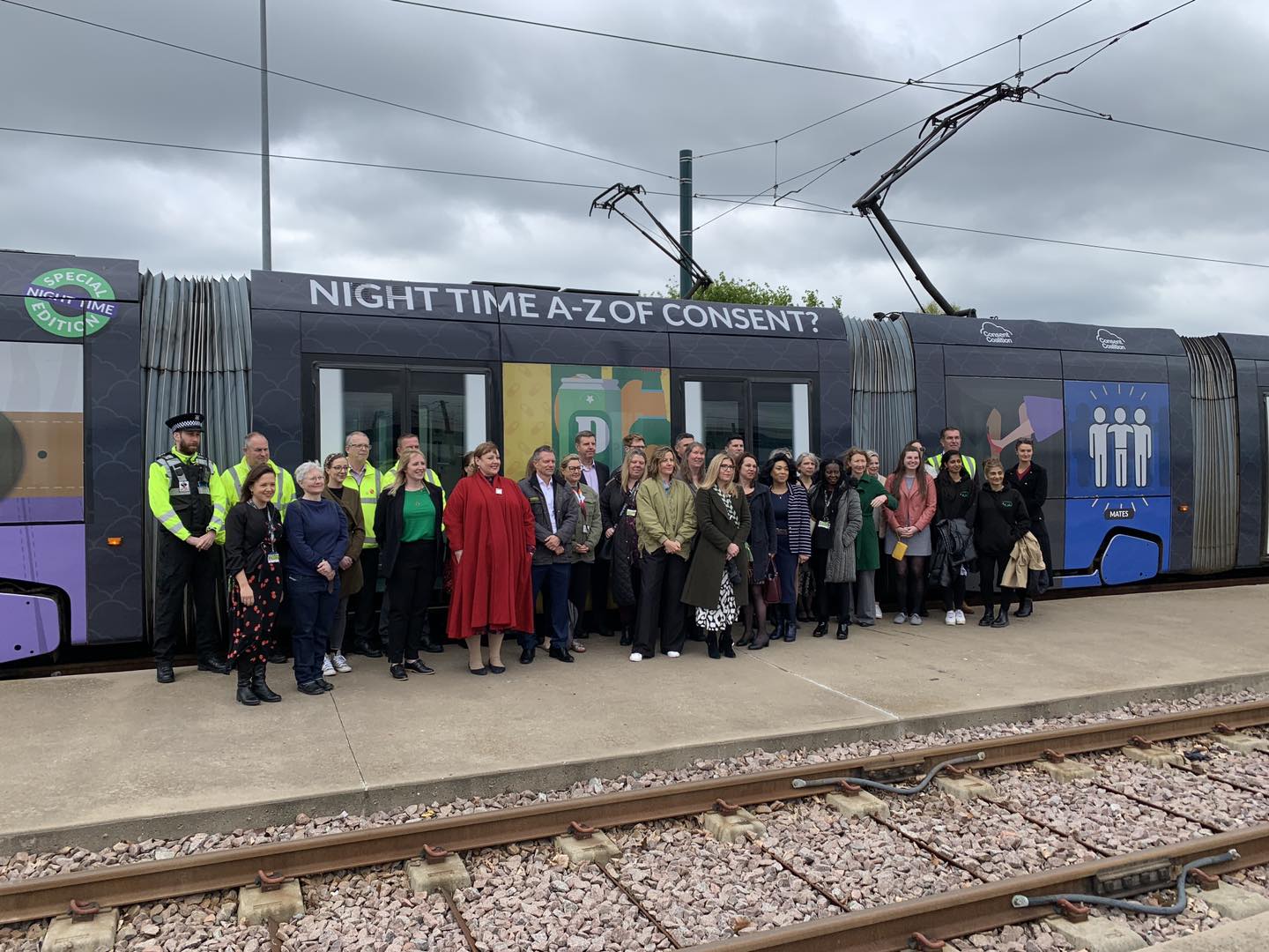 People gather in front of the new tram