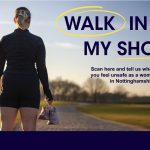 A picture of a woman in an open park area, carrying a pair of trainers, in the daytime. 'Walk in My Shoes' is written in dark purple text against the sky.