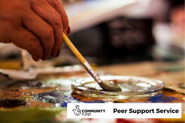 3 Close up of a hand dipping an art brush on a pallet. In the bottom right is the National Lottery Community Fund logo and the words 'Peer Support Service'